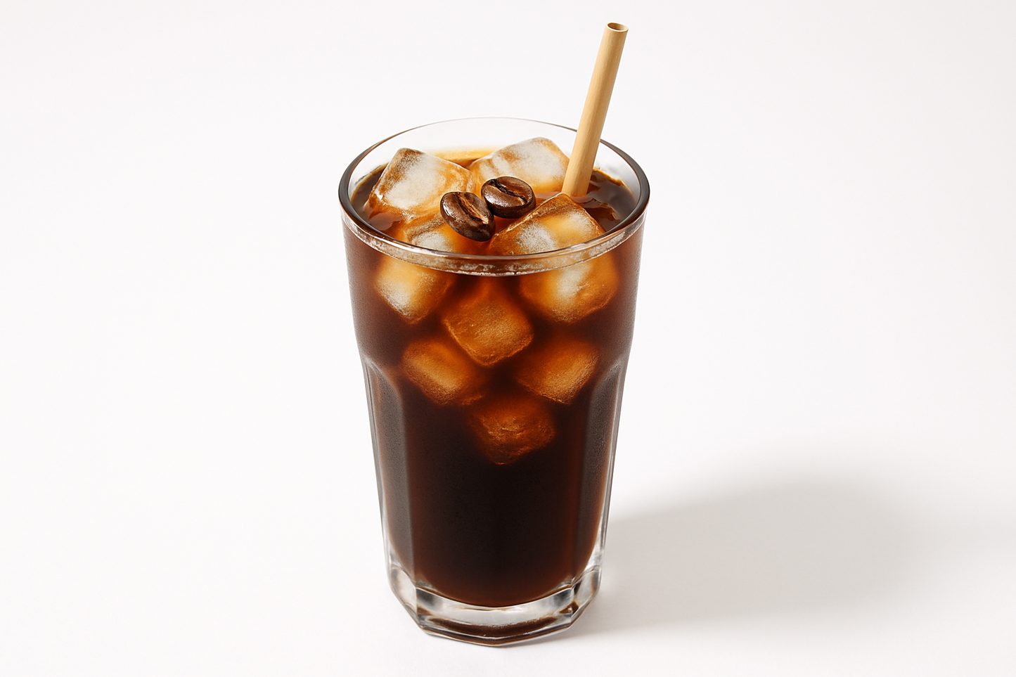 Glass of sexy iced coffee with a straw on a white background with premium og straw requested by whitehouse staff